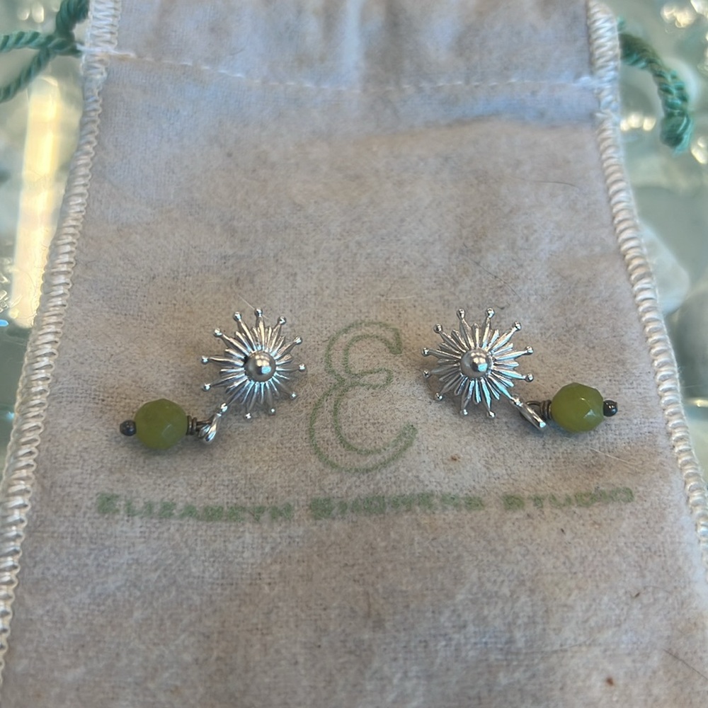 Elizabeth showers silver star burst earrings with drop green